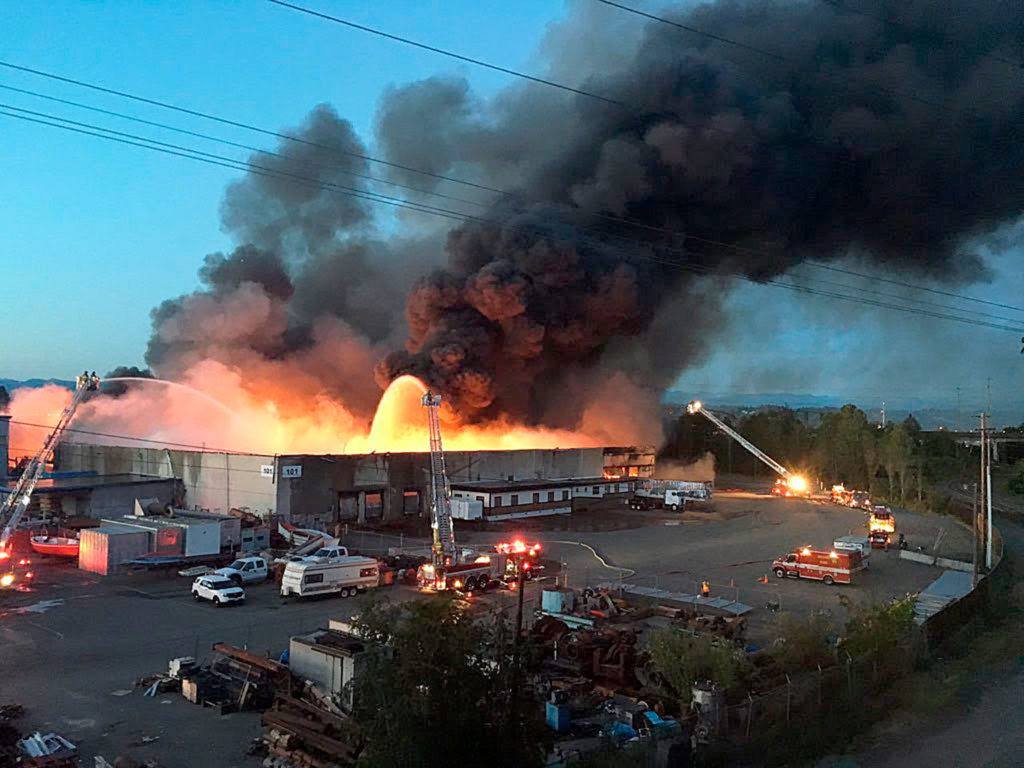 Firefighters from throughout Snohomish County battled a massive three-alarm warehouse fire along the Snohomish River in north Everett on June 4, 2016. (Doug Ramsay / Herald file)

