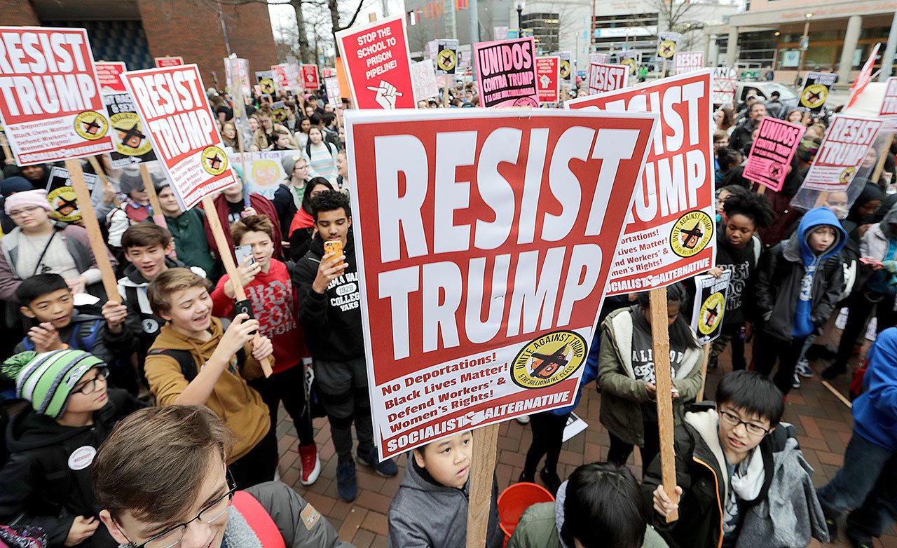 Protesting high school and college student mark Inauguration Day at Seattle Central College on Friday. (AP Photo/Elaine Thompson)