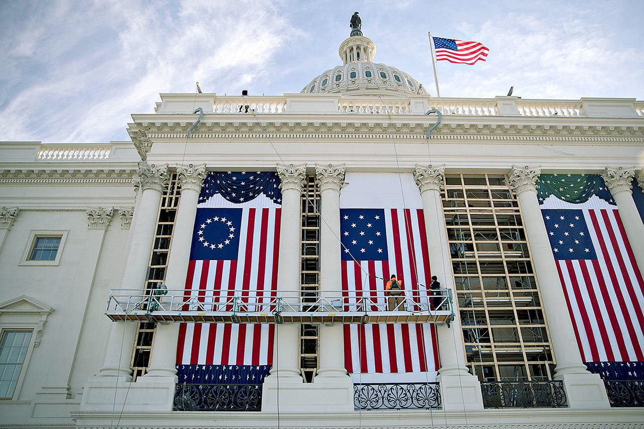 Workers adjust an American flag at the U.S. Capitol during rehearsal for the 2017 Inaugural Ceremonies in Washington. (Andrew Harrer/Bloomberg News)