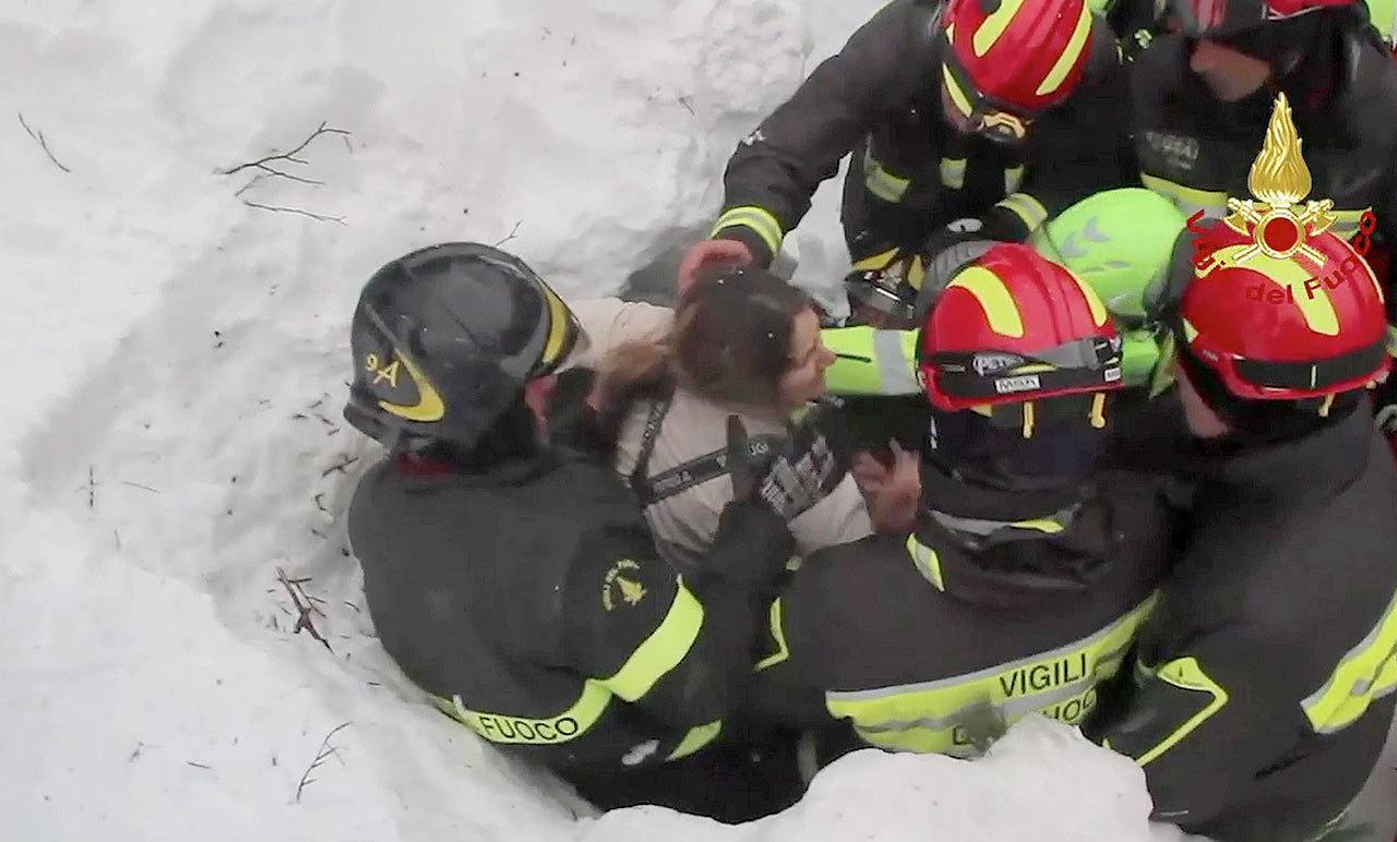 Italian firefighters on Friday extract a woman from under snow and debris of a hotel that was hit by an avalanche on Wednesday in Rigopiano, Italy. (Italian Firfighters/ANSA via AP)