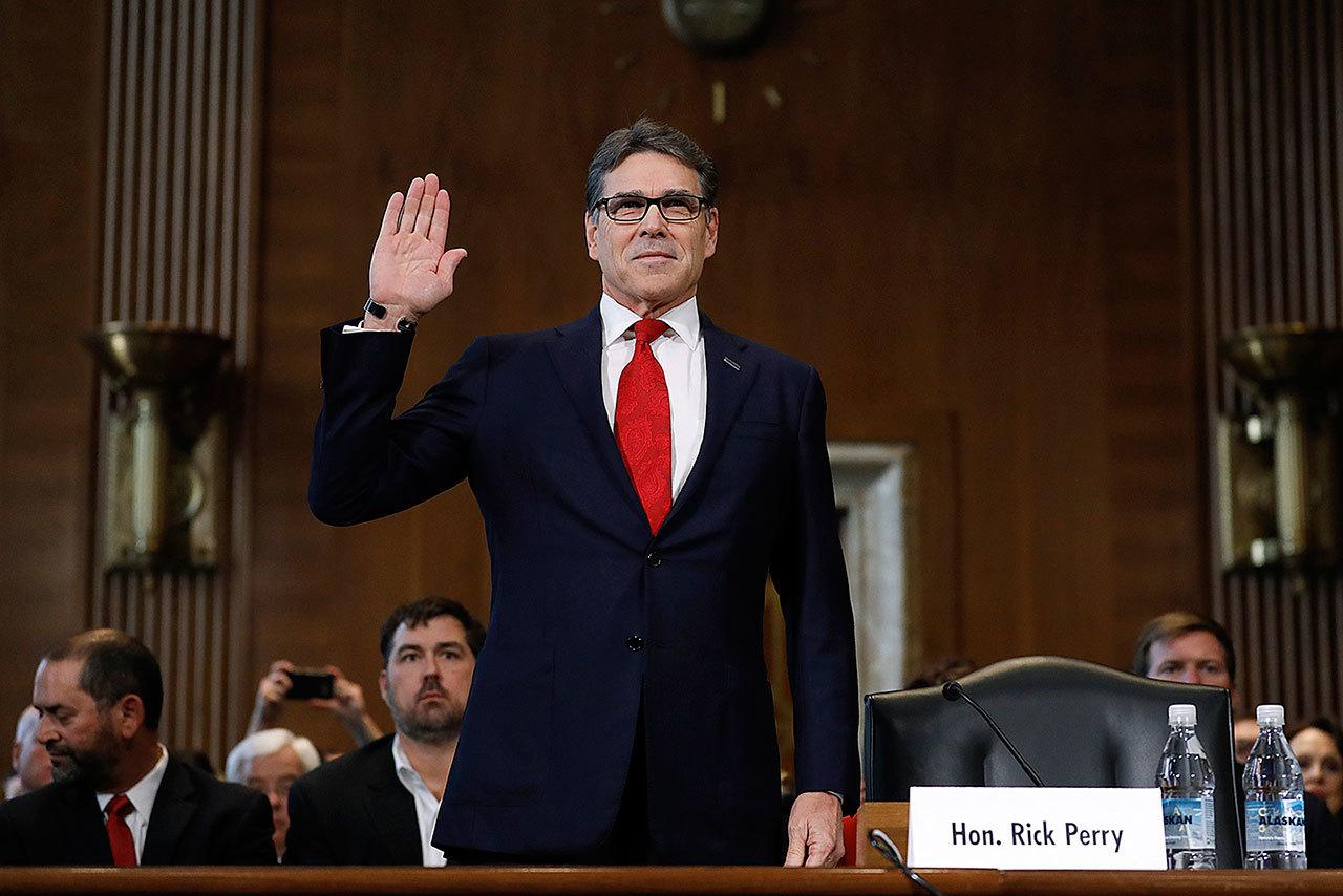 Energy Secretary-designate, former Texas Gov. Rick Perry, is sworn-in on Capitol Hill in Washington on Thursday, Jan. 19, prior to testifying at his confirmation hearing before the Senate Energy and Natural Resources Committee. (AP Photo/Carolyn Kaster)