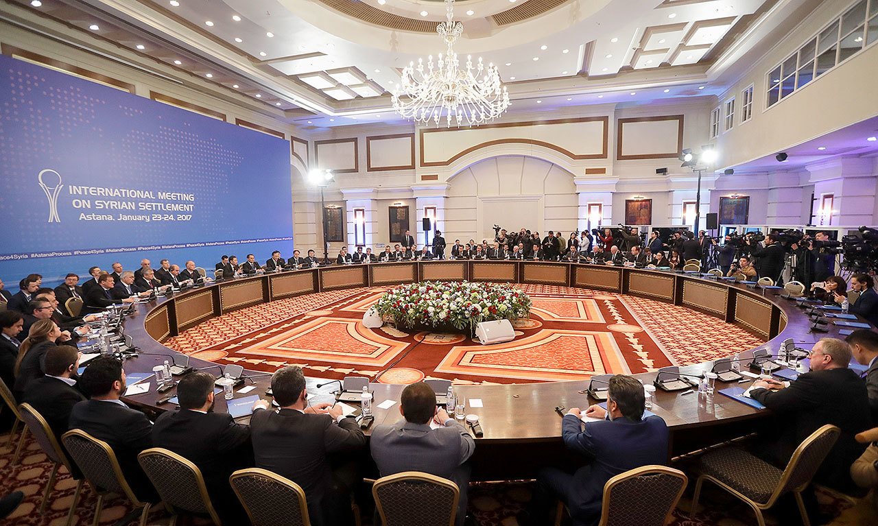Delegations of Russia, Iran and Turkey hold talks on Syrian peace at a hotel in Astana, Kazakhstan, on Monday. (AP Photo/Sergei Grits)