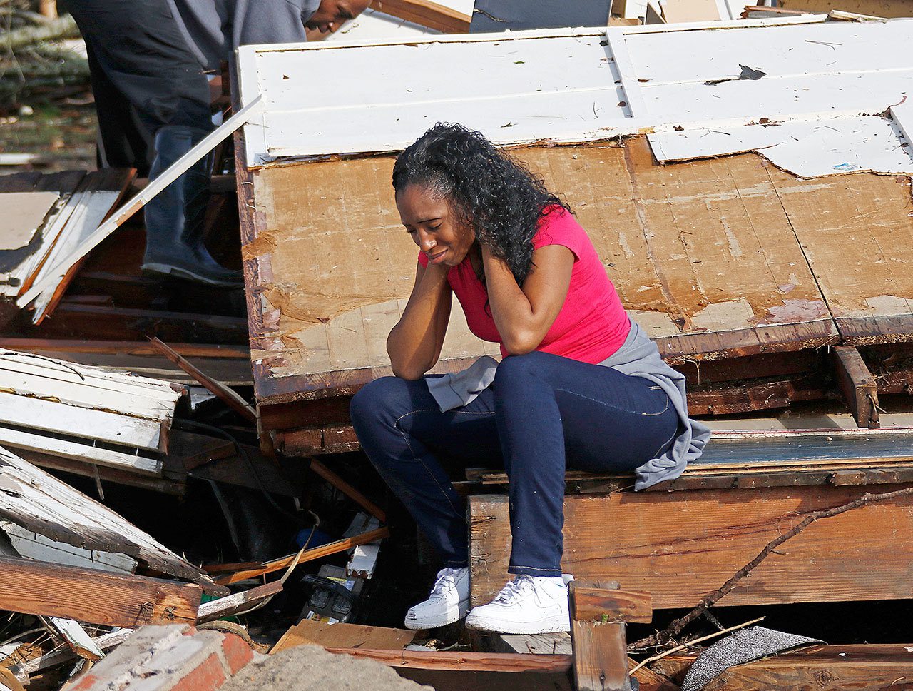 Shanise McMorris grieves in the wreckage of her Hattiesburg home after an early morning tornado hit the city Saturday. (AP Photo/Rogelio Solis)