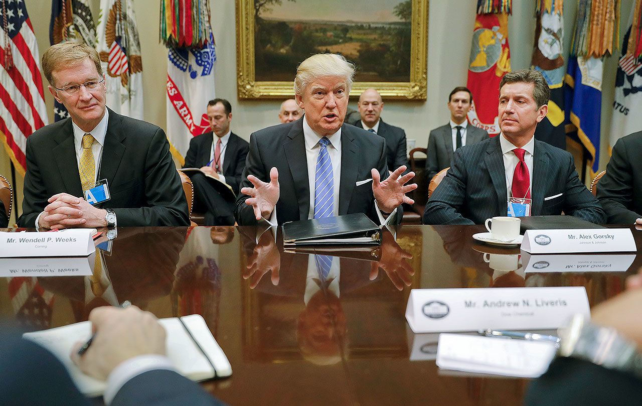 President Donald Trump speaks while hosting a breakfast with business leaders in the Roosevelt Room of the White House in Washington on Monday. At left is Wendell P. Weeks, chief executive officer of Corning, and at right is Alex Gorsky, chairman and chief executive officer of Johnson & Johnson. (AP Photo/Pablo Martinez Monsivais)
