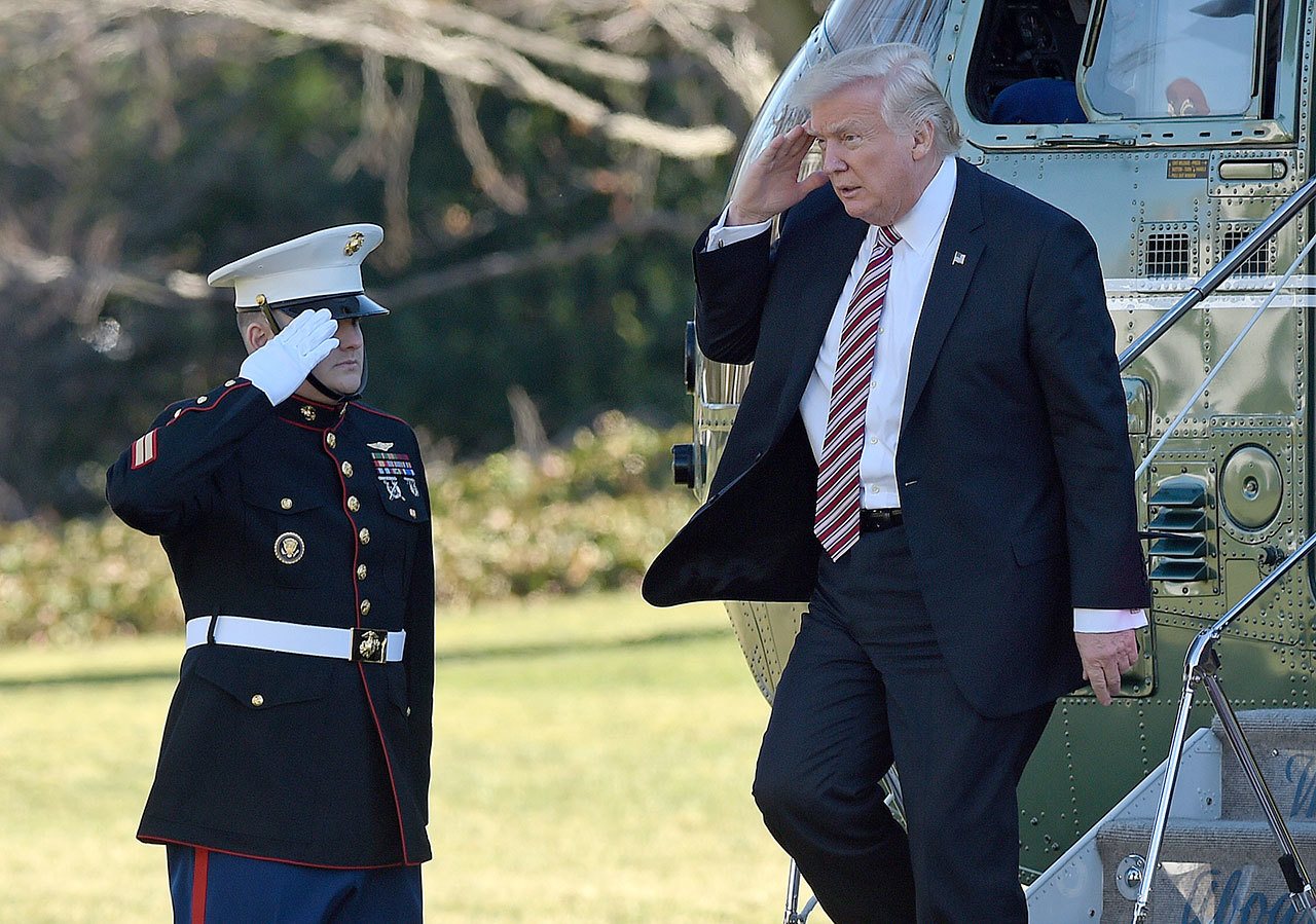President Donald Trump salutes as he walks off of Marine One on the South Lawn of the White House on Thursday. (AP Photo/Susan Walsh)