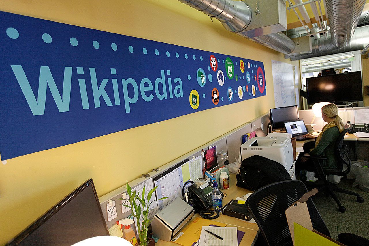 In this 2012 photo, Mallory Whitt works at her desk at the offices of the Wikipedia Foundation in San Francisco. (AP Photo/Eric Risberg, File)