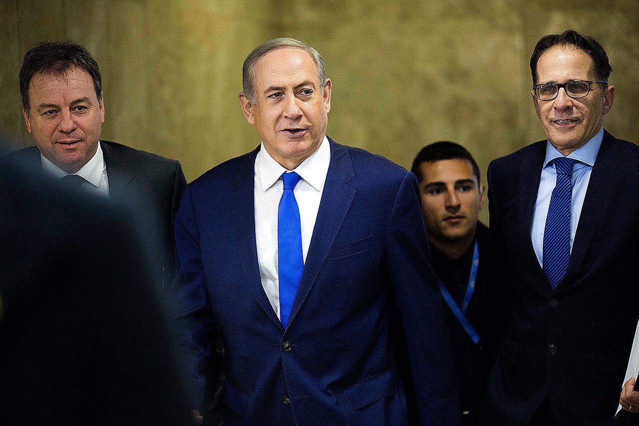 Israeli Prime Minister Benjamin Netanyahu (center) arrives to the weekly cabinet meeting at his office in Jerusalem on Sunday, Jan. 8. (Abir Sultan, Pool via AP)