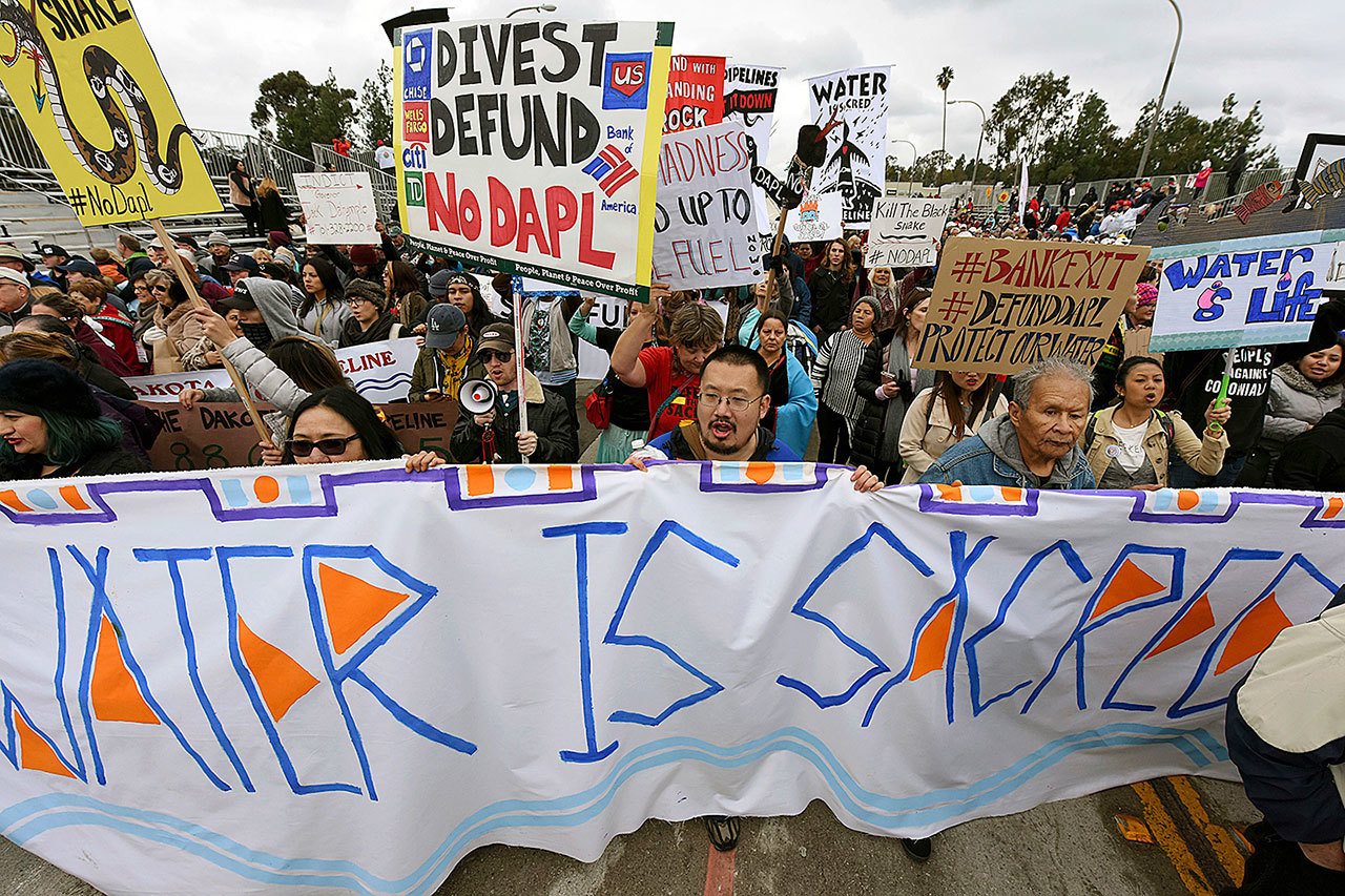 In this Jan. 2 photo, protesters rally against the Dakota Access Pipeline behind the 128th Rose Parade in Pasadena, California. The front lines of the battle against the $3.8 billion Dakota Access pipeline are shifting away from the dwindling encampment in North Dakota. (AP Photo/Michael Owen Baker, File)