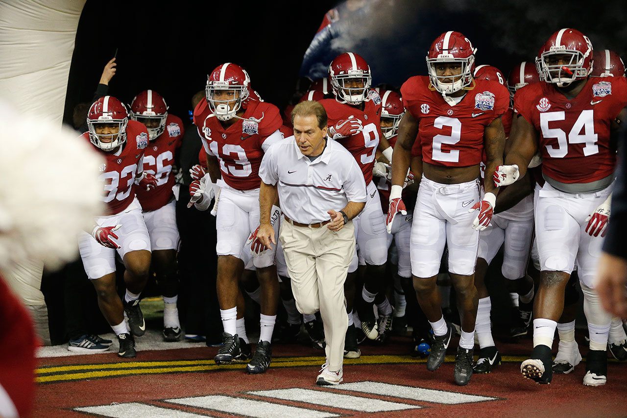 Head coach Nick Saban and the Alabama team enter the field before the first half of the Peach Bowl playoff game against Washington on Dec. 31 in Atlanta. (AP Photo/John Bazemore)