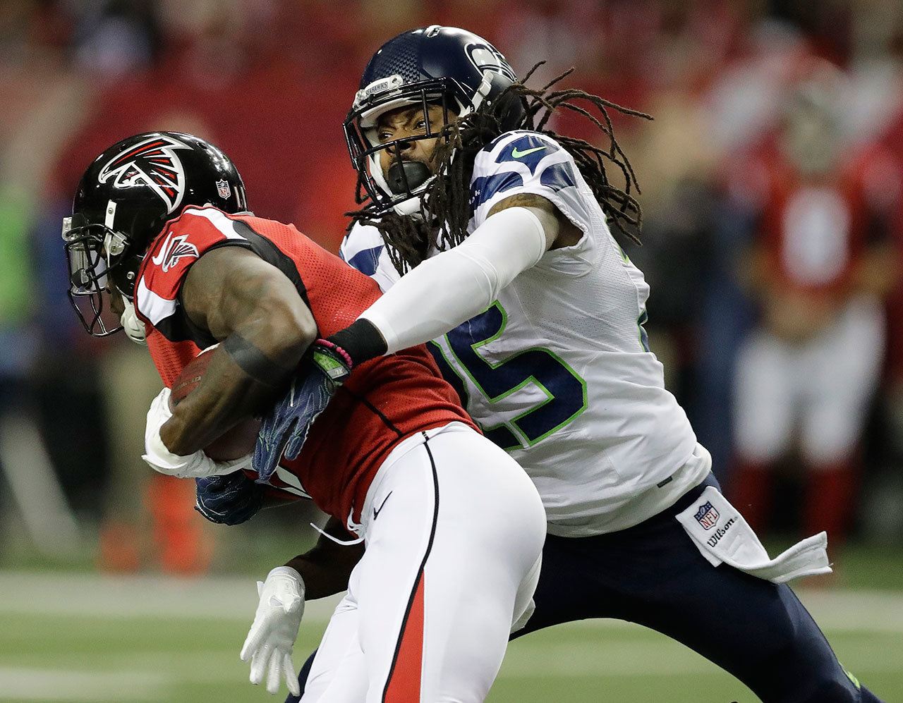 Seahawks cornerback Richard Sherman (25) tackles Falcons wide receiver Julio Jones (11) during the first half of an NFC divisional playoff game this past Saturday in Atlanta. (AP Photo/David Goldman)