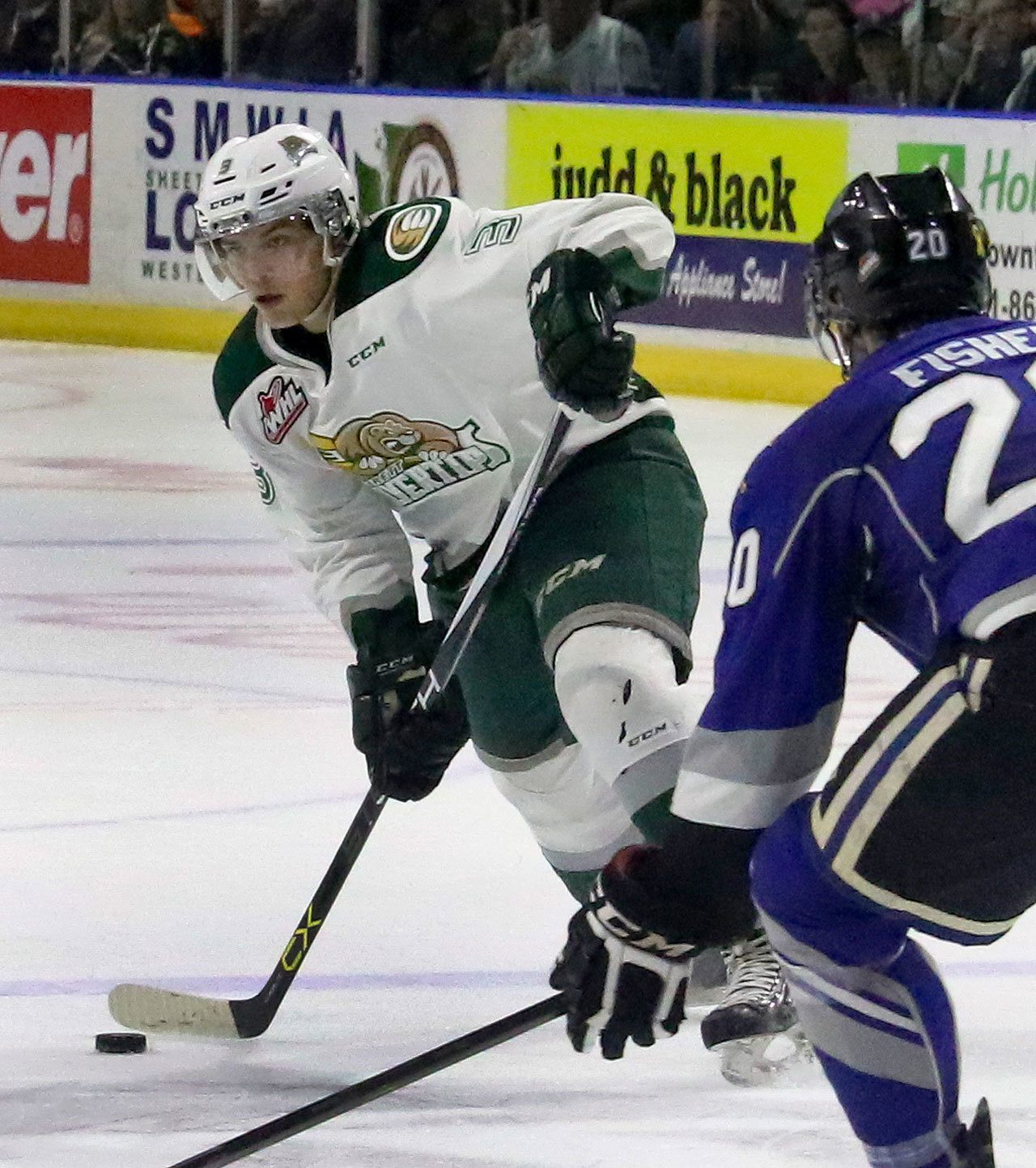 The Silvertips’ Noah Juulsen looks to pass with the Royals’ Logan Fisher defending during a game last season at Xfinity Arena in Everett. (Kevin Clark / The Herald)