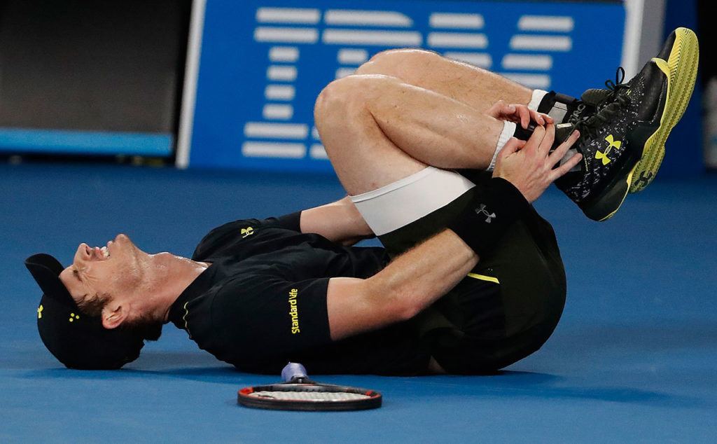 Britain’s Andy Murray reacts after injuring his ankle Wednesday during his second-round match against Russia’s Andrey Rublev at the Australian Open tennis championships in Melbourne, Australia. (AP Photo/Dita Alangkara)
