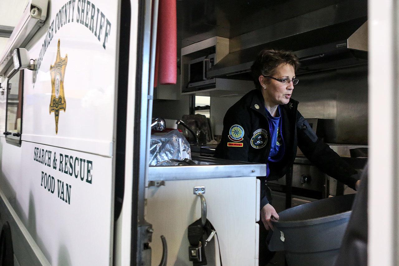 Debra Draper clears the aisle during her weekly maintenance on SSAR 70, the food truck. Draper joined Snohomish County Volunteer & Resuce during the Oso mudslide response and operates the food truck. (Kevin Clark / The Herald)