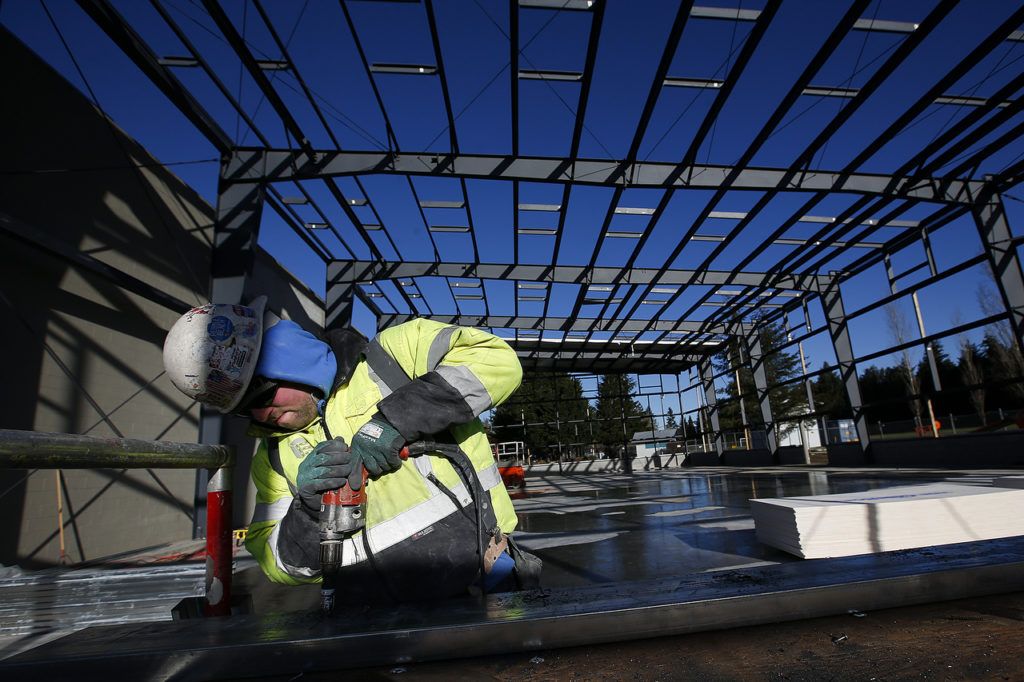 Tom Ertl works on the frame of the Arlington Boys and Girls Club’s new gym Wednesday. The new gym will be about the same width as the old one but will be longer, allowing for another set of basketball hoops. (Ian Terry / The Herald)
