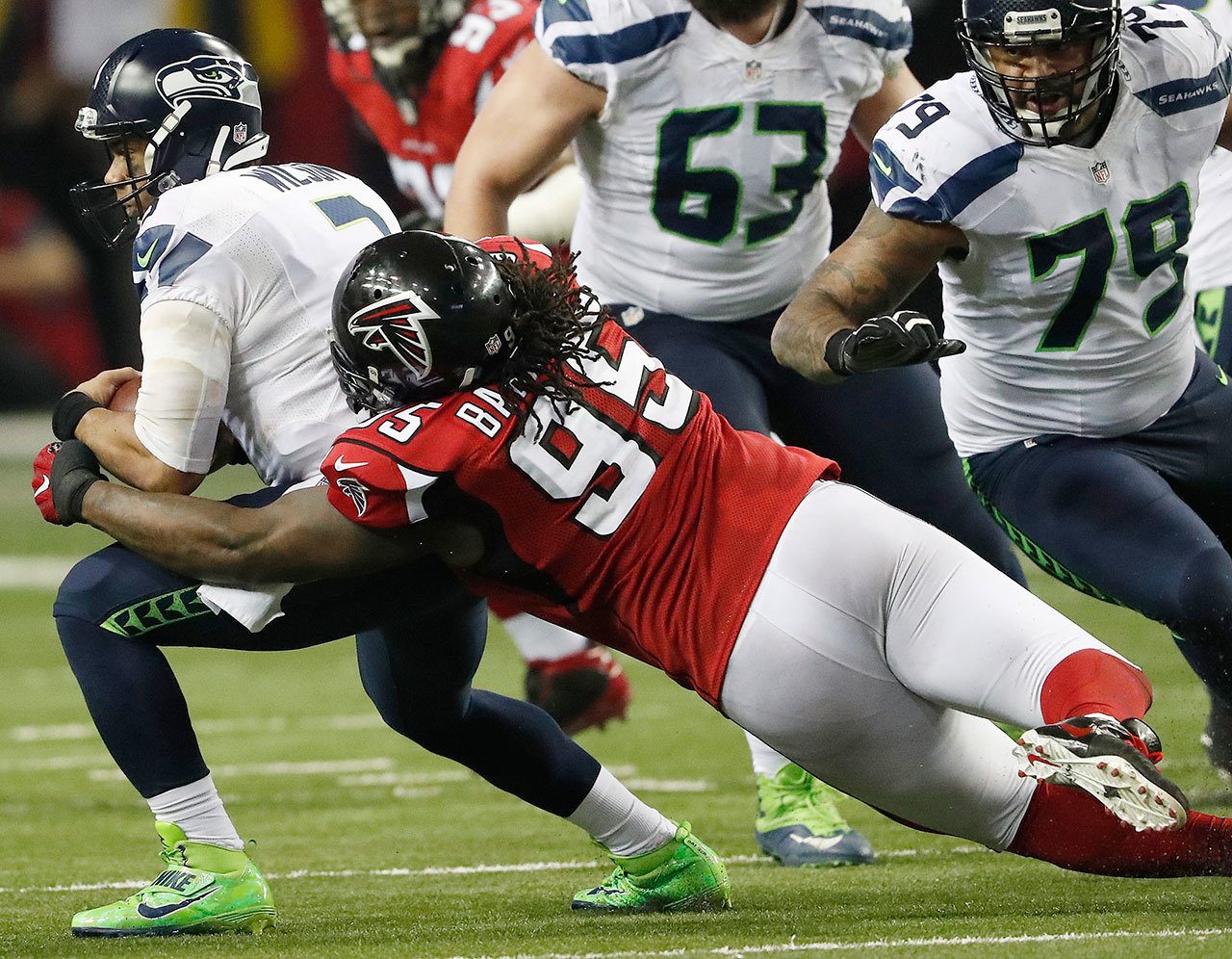Falcons defensive tackle Jonathan Babineaux (95) sacks Seahawks quarterback Russell Wilson (3) during the second half of a playoff game Saturday in Atlanta. The Falcons won 36-20. (AP Photo/John Bazemore)