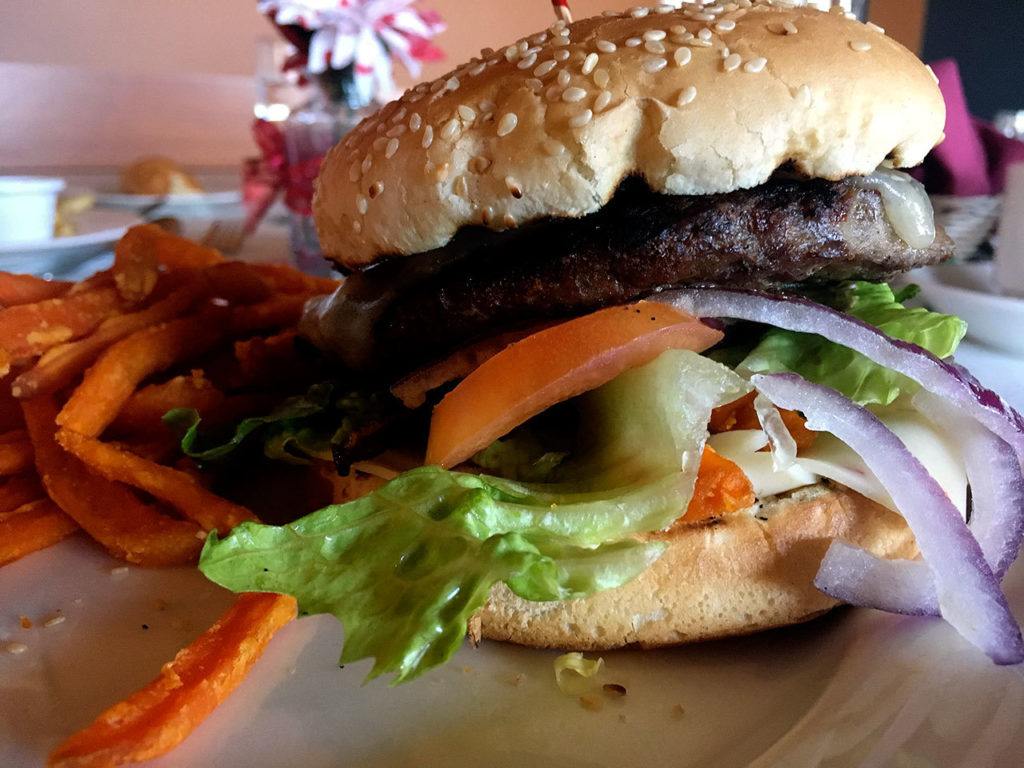 Ben Watanabe / The Herald
A cheeseburger at Le Bistro is topped with your choice of cheese, mayonnaise, lettuce, tomato, mustard and red onions for $6.
