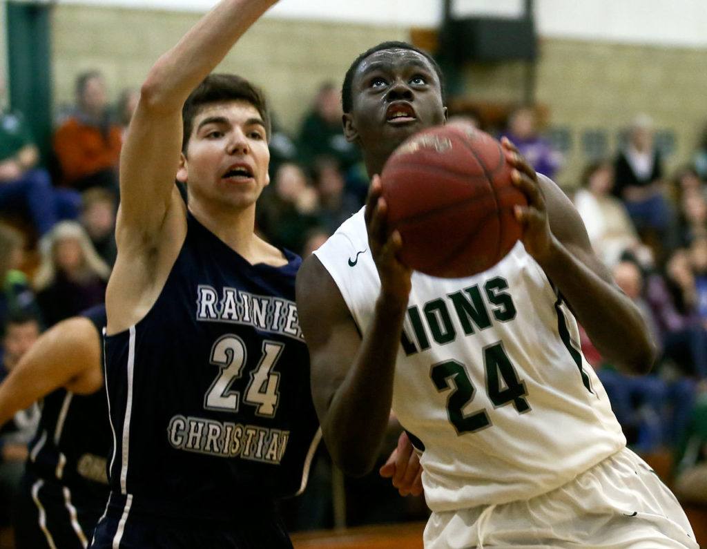 Hunter Whitchurch of Rainier Christian defends and trails Erwin Weary of Cedar Park Christian Thursday night at Cedar Park Christian School in Mountlake Terrace on December 29, 2016. (Kevin Clark / The Herald)
