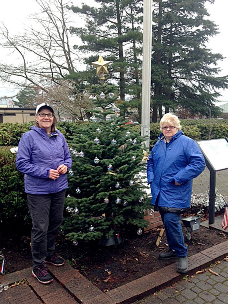 A decorated Honor Tree, honoring local active duty military and veterans, was displayed at Lynnwood Veterans Park over the holidays. The tree was donated by the Aurora Village Home Depot. Pictured are Veterans of Foreign Wars Post 1040 Auxiliary President Jan Beam and Auxiliary member Myra Rintamaki. (Contributed photo)
