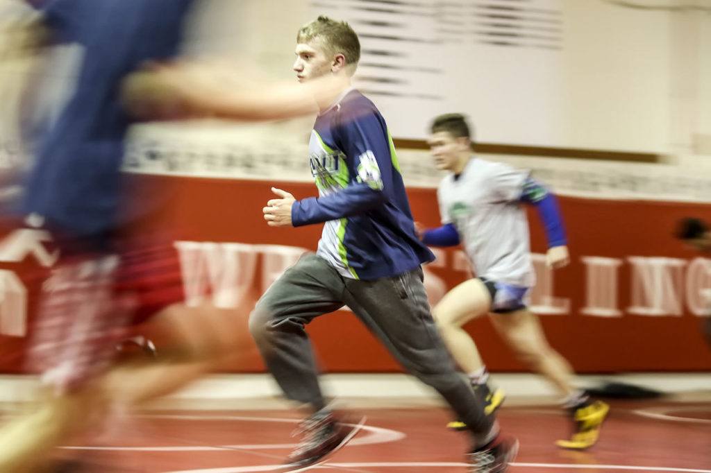 Stanwood’s Mason Phillips (center) runs through drills during practice Jan. 5 at Stanwood High School. (Kevin Clark / The Herald)
