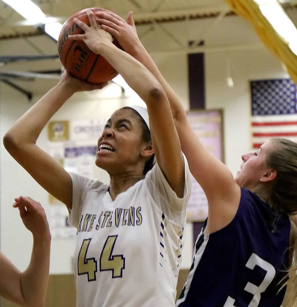 Lake Stevens’ Kylee Griffen attempts a shot with Kamiak’s Alex Gallaher (right) defending Wednesday night in Lake Stevens. The Vikings won 65-61. (Kevin Clark / The Herald)
