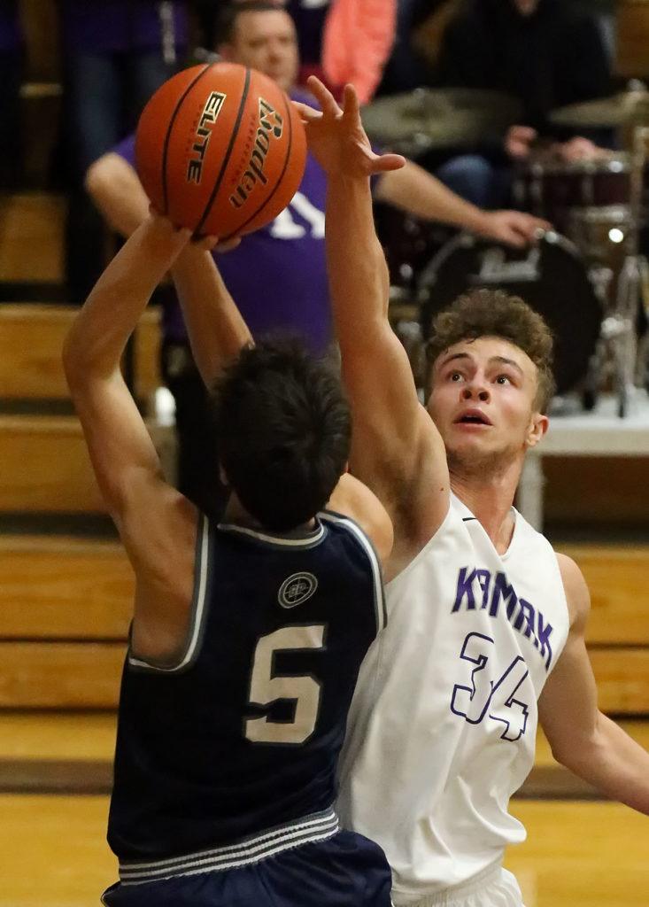 Glacier Peak’s Justin Purcell attempts a shot over Kamiak’s Daniel Sharpe during a game Friday night at Kamiak High School in Mukilteo. The Grizzles won 63-50. (Kevin Clark / The Herald)
