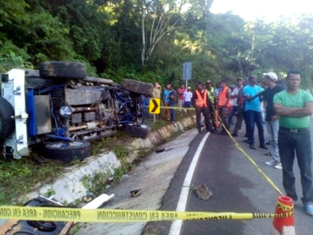 Locals and authorities stand at the fatal crash site of MLB player Yordano Ventura near Juan Adrian, Dominican Republic, Sunday, Jan. 22, 2017. Ventura was a pitcher for the Kansas City Royals whose electric arm and confident demeanor helped lead to a long-awaited World Series championship in 2015. He died in this car crash in his native Dominican Republic early Sunday. He was 25. (Dominican Republic Highway Police and Military Commission, via AP)