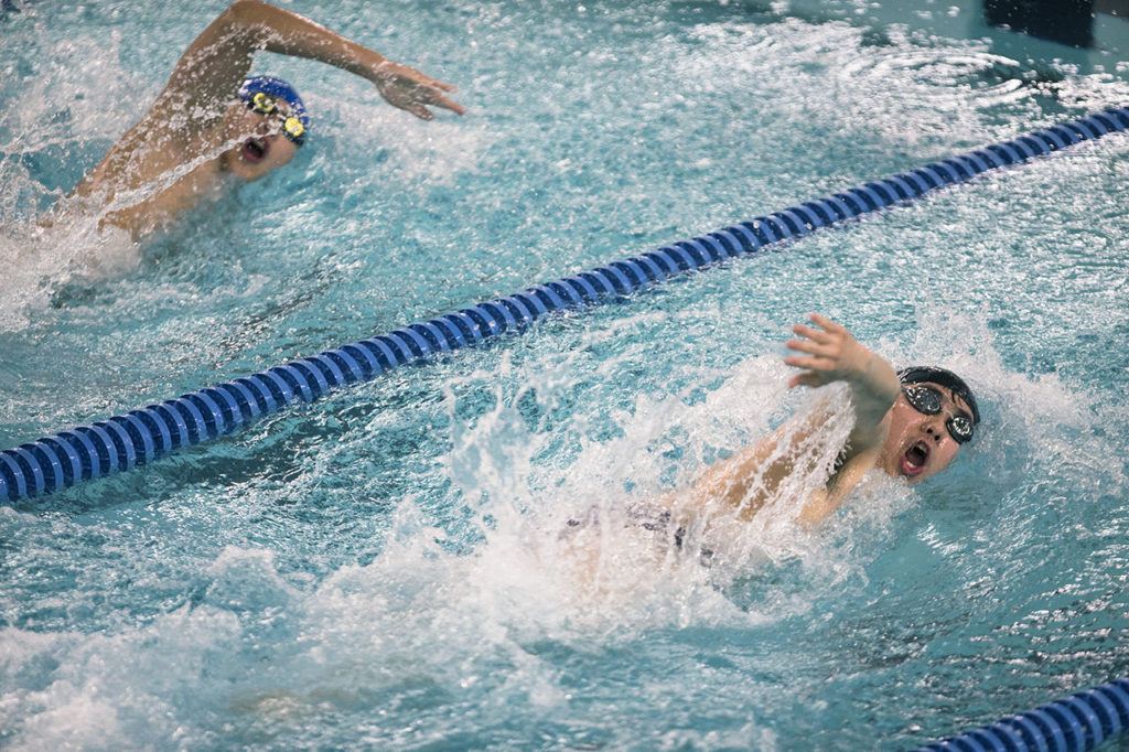 Kamiak’s Brian Park (right) swims a close race with Shorewood’s Andrew Butcher during the 100 freestyle on Tuesday in Shoreline. (Daniella Beccaria / The Herald)
