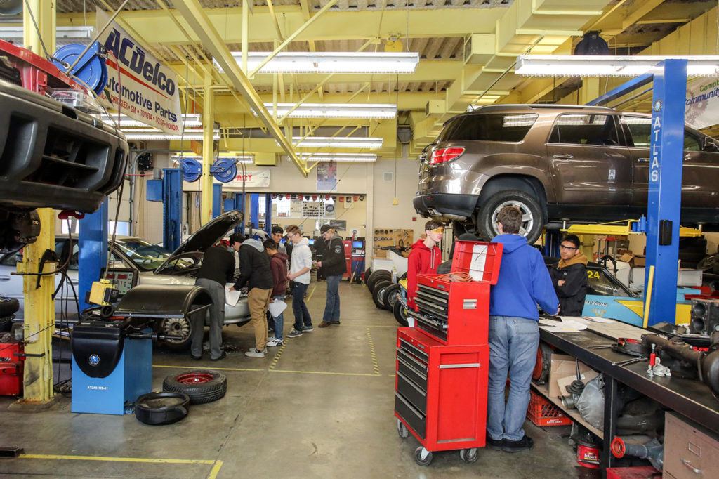 Students work through the course work in the automotive class at Meadowdale High School on Thursday afternoon in Lynnwood. (Kevin Clark / The Herald)
