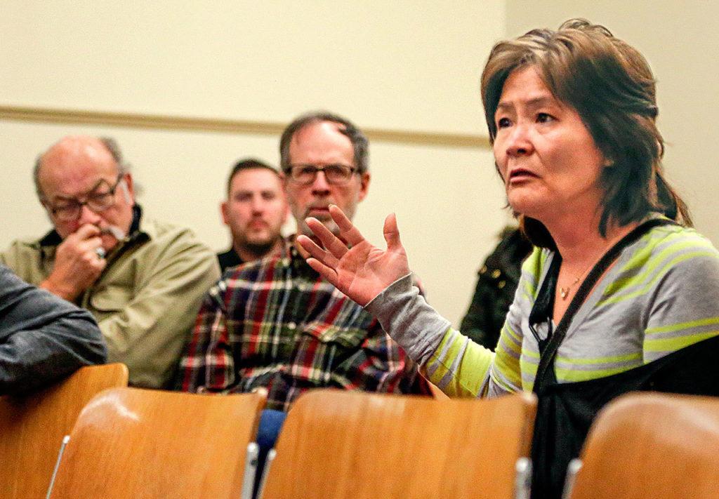 At a meeting with social workers and an Everett police sergeant, Maile Leavitt speaks up, saying she “lives in fear” at her apartment in the 2600 block of Rucker Avenue. (Dan Bates / The Herald)
