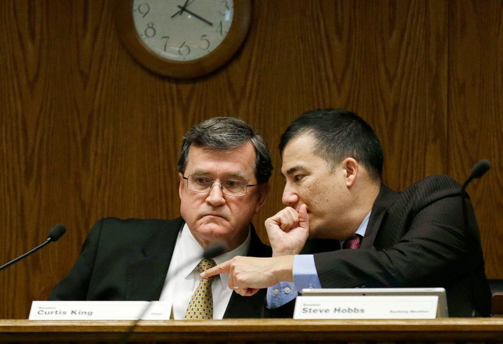 Sen. Curtis King, R-Yakima (left) confers with Sen. Steve Hobbs, D-Lake Stevens, as they listen to testimony Thursday during a Senate Transportation Committee hearing dealing with the federal government’s REAL ID act, which requires state driver’s licenses and I.D. cards to have security enhancements and be issued to people who can prove they’re legally in the United States. (Ted S. Warren / Associated Press)
