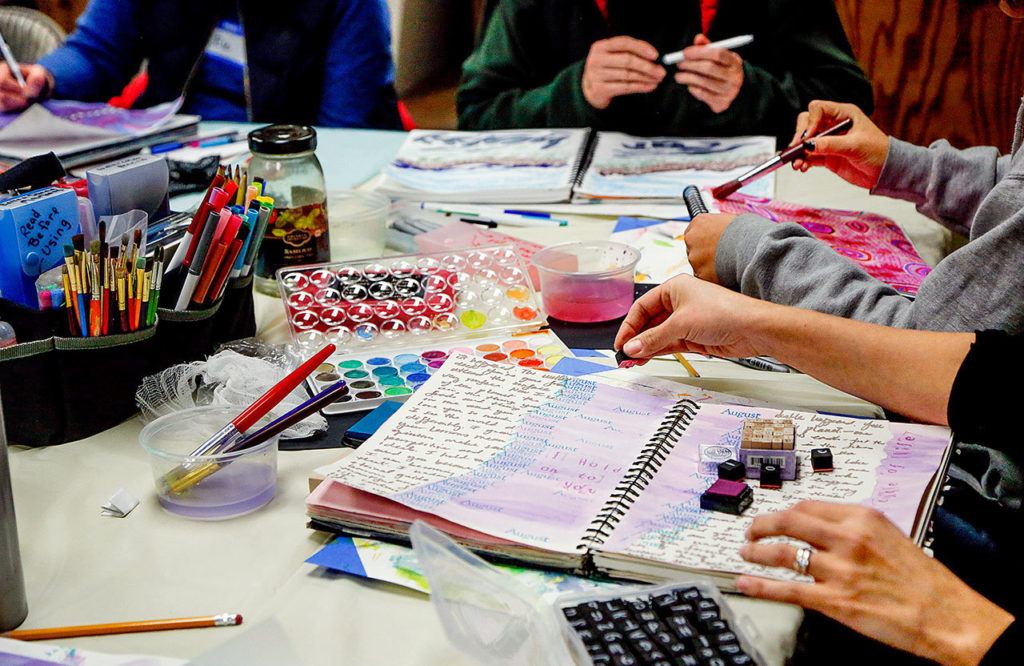 Using a variety of tools and media, women express themselves through visual journaling last week at ArtWorks in Edmonds. (Dan Bates / The Herald)
