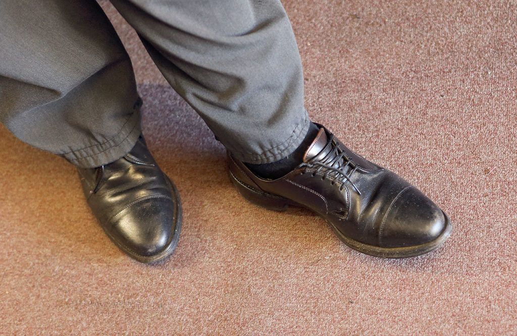 Mike Papadimitriou, owner of People’s Shoe Repair, wears a pair of American-made Allen Edmonds shoes at his shop. (Andy Bronson / The Herald)
