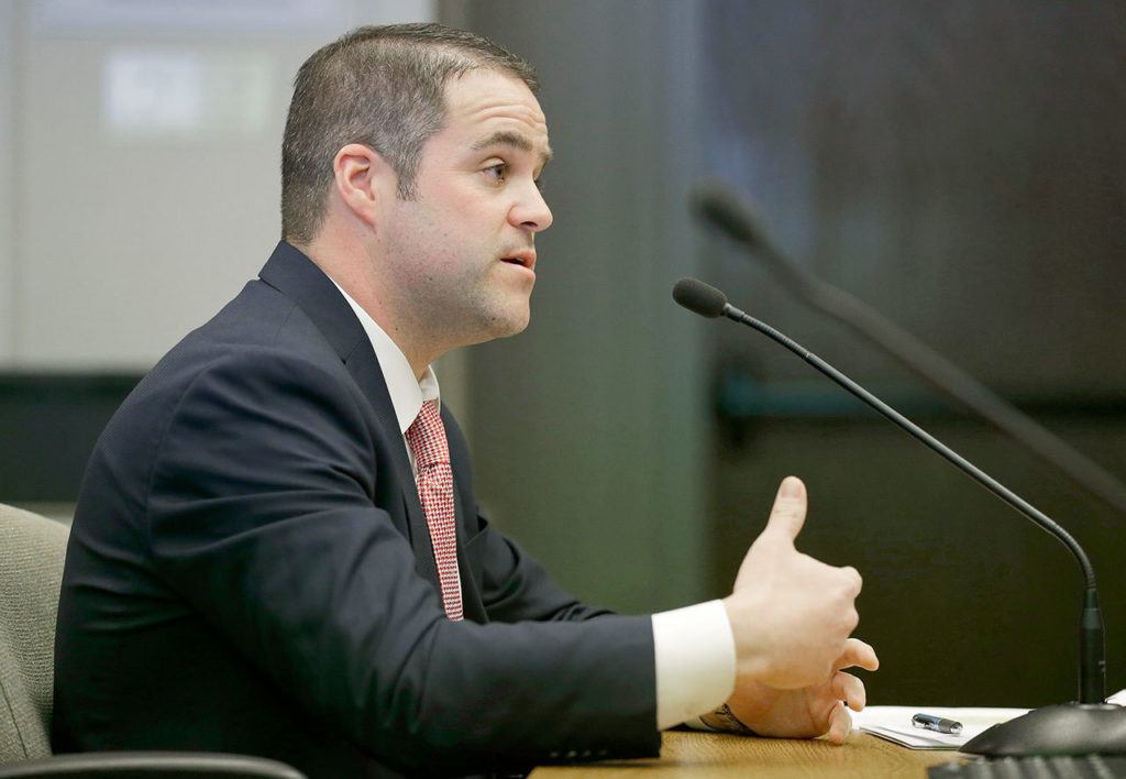 Tony Sermonti, policy and legislative director for the Washington Department of Licensing, speaks during the hearing. (Ted S. Warren / Associated Press)
