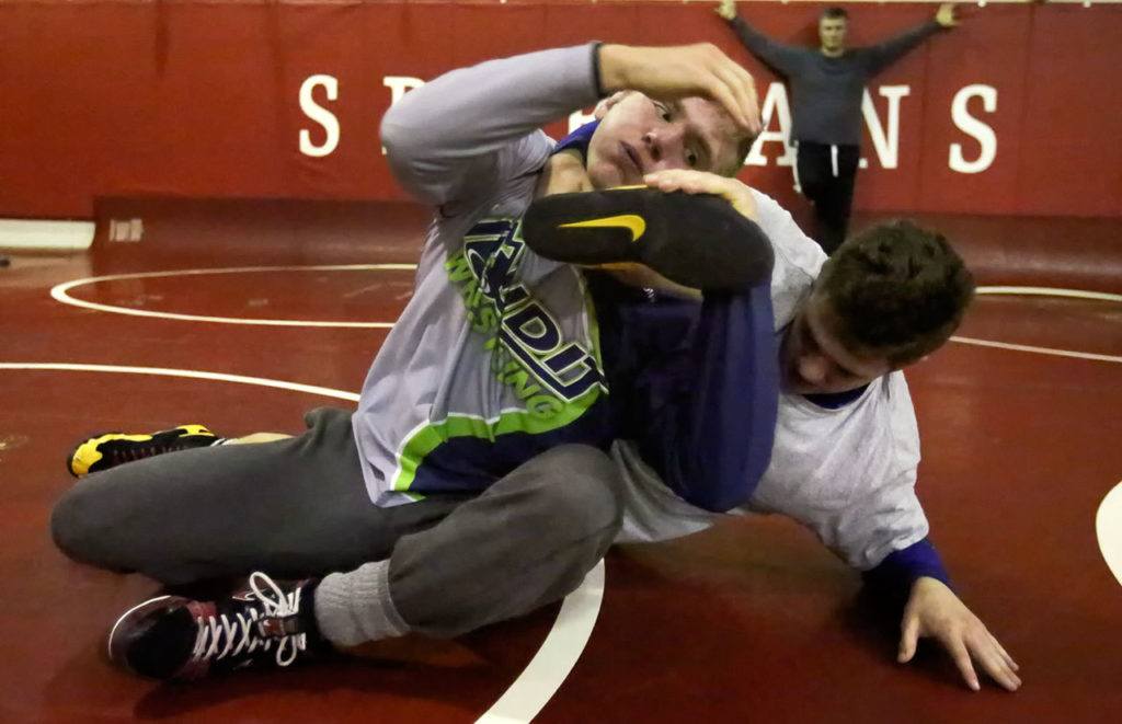 Stanwood’s Mason Phillips (left) and Riley Van Scoy wrestle during practice on Jan. 5 at Stanwood High School. (Kevin Clark / The Herald)
