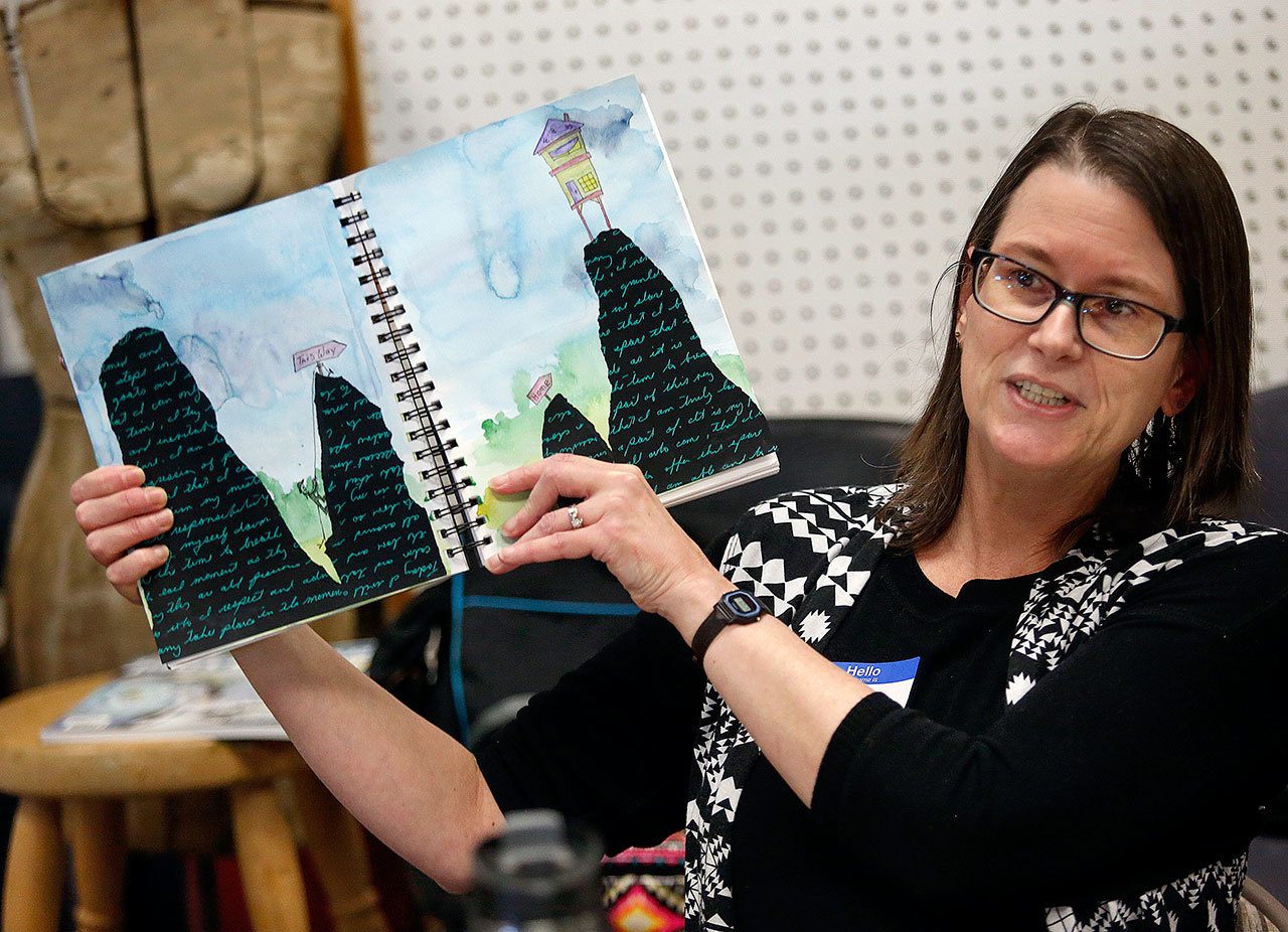 At the beginning of the workshop, Dawn talks about and shows a few different appoaches to visual journaling, including one she is currently working on. (Dan Bates / The Herald)
