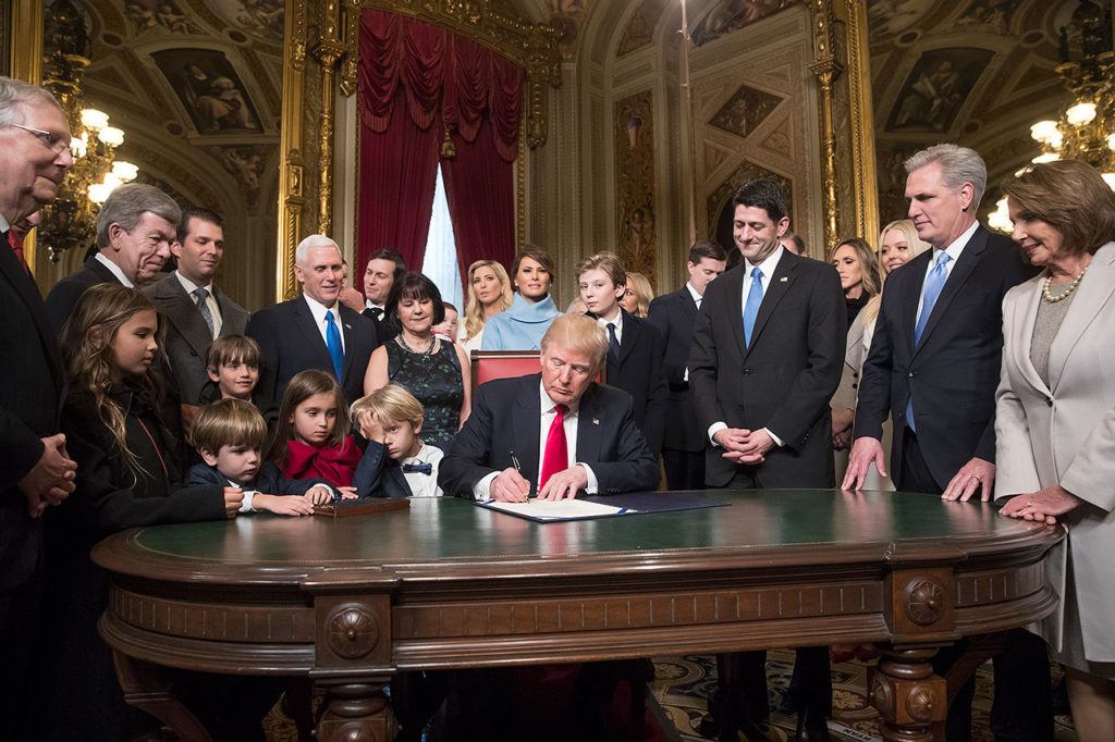 President Donald Trump is joined by the Congressional leadership and his family as he formally signs his cabinet nominations into law Friday, Jan. 20, in the President’s Room of the Senate on Capitol Hill in Washington. From left are, Senate Majority Leader Mitch McConnell, Sen. Roy Blunt, Donald Trump Jr., Vice President Mike Pence, Jared Kushner, Karen Pence, Ivanka Trump, Melania Trump, Barron Trump, Speaker of the House Paul Ryan, Majority Leader Kevin McCarthy and House Minority Leader Nancy Pelosi. (AP Photo/J. Scott Applewhite, Pool)
