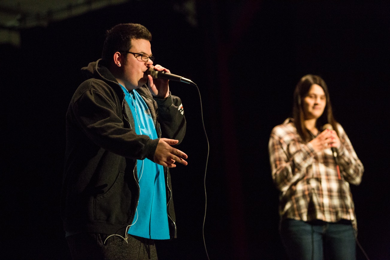 Keith Lasher raps while his girlfriend, Regan Harris, sings during the “We Day” celebration and birthday party at Marysville Pilchuck High School on Saturday. Lasher’s former teacher, Jim Strickland, inspired him to turn his birthday into a community event and fundraiser to build a school in Kenya. (Daniella Beccaria / The Herald)