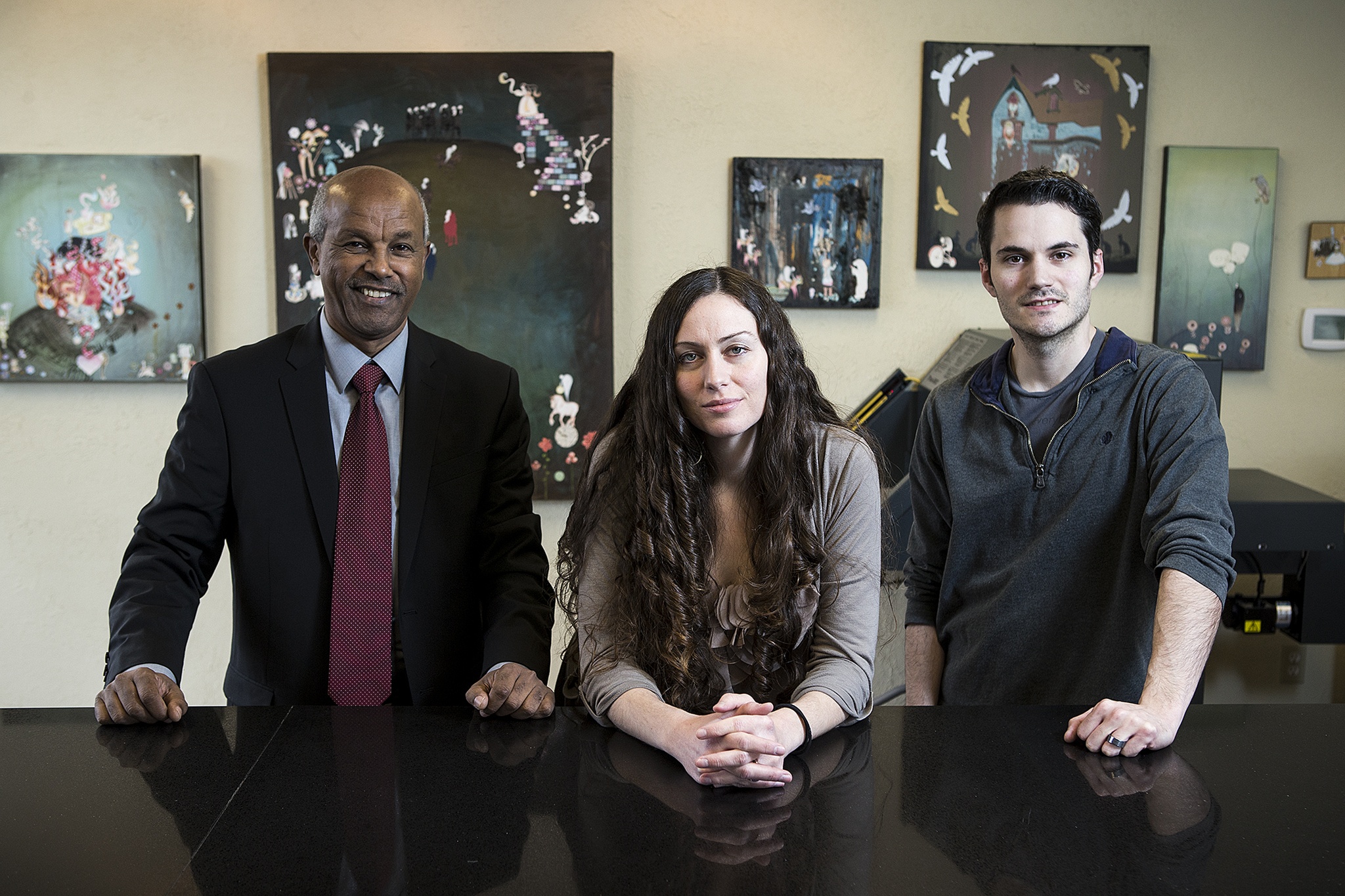 Production manager Mesfin Mengesha, left, art director Lillyan Hendershot and web developer Timothy Hendershot own and run Branding Iron, a marketing firm in Edmonds. (Ian Terry / The Herald)
