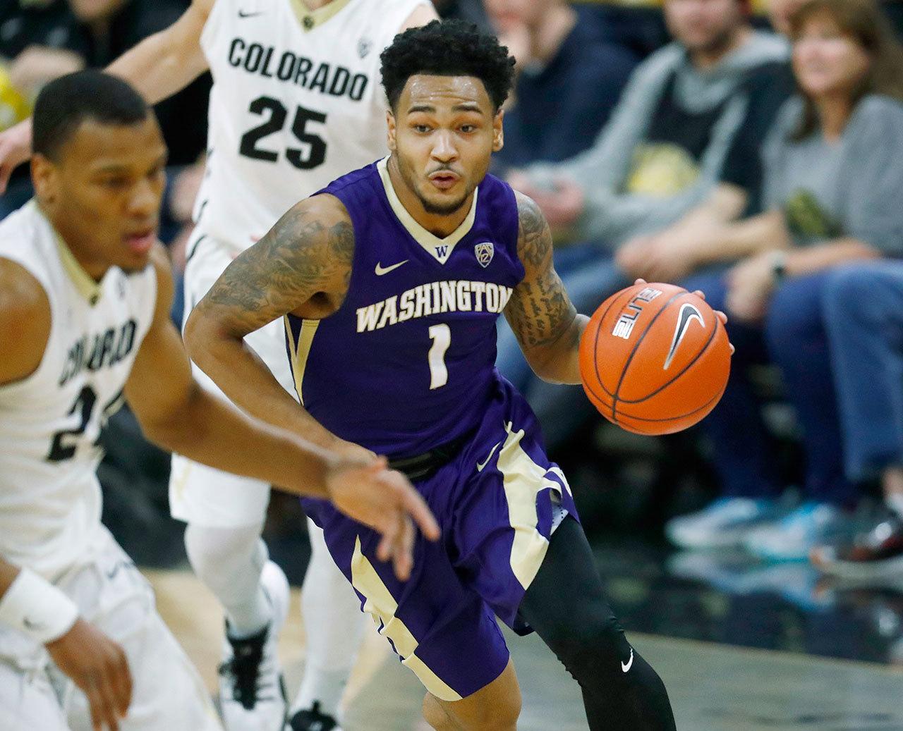 Washington’s David Crisp (right) drives past Colorado’s George King after a steal in the first half of the Huskies’ 81-66 loss to the Buffaloes on Thursday in Boulder, Colo. (AP Photo/David Zalubowski)
