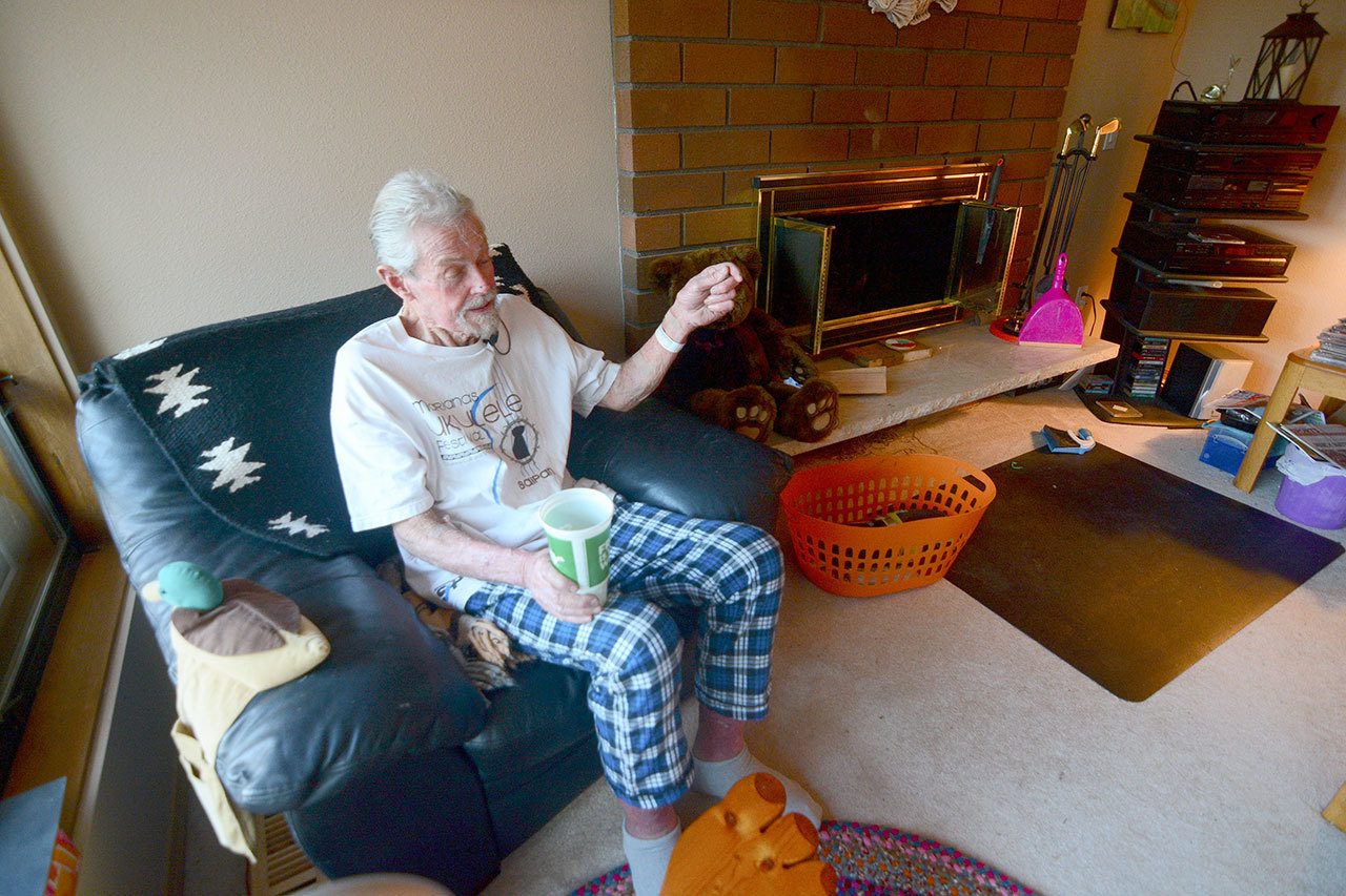 Richard Jones of Sunland, 69, talks to reporters in his home Monday after being rescued from his car earlier that morning. He was trapped in his car for five days. (Jesse Major / Peninsula Daily News)