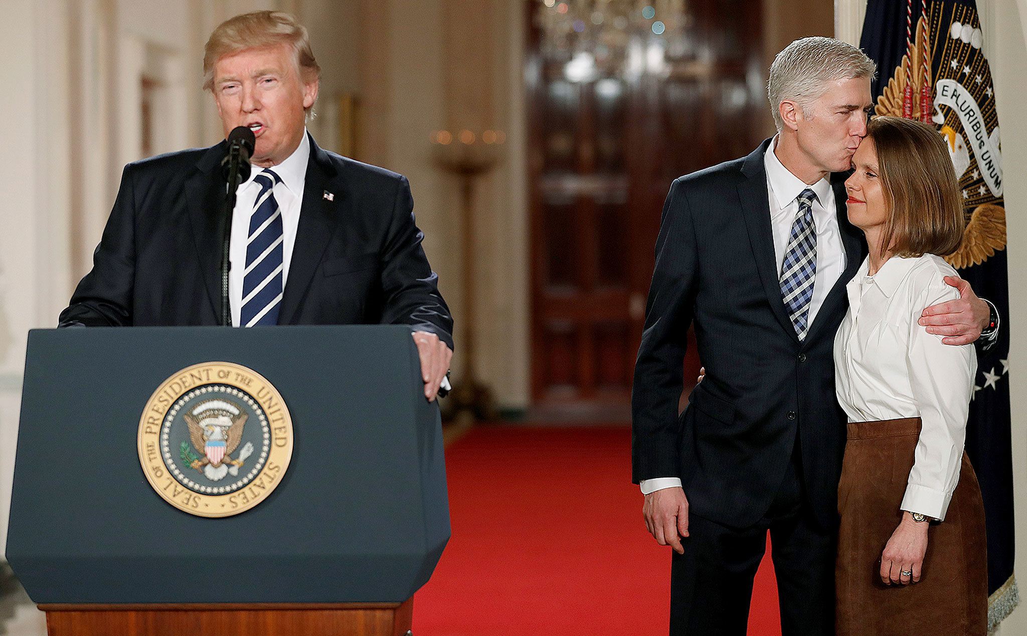 President Donald Trump speaks in the East Room of the White House in Washington on Tuesday to announce Judge Neil Gorsuch as his nominee for the Supreme Court. Gorsuch stands with his wife, Louise. (AP Photo/Carolyn Kaster)