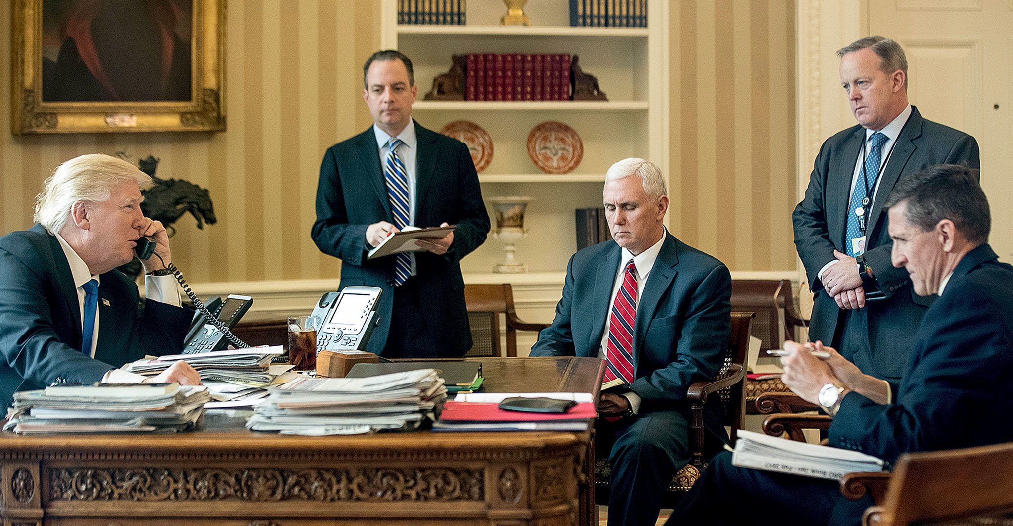 On Jan. 28, President Donald Trump speaks on the phone with Russian President Vladimir Putin in the Oval Office at the White House in Washington. From second from left: Chief of Staff Reince Priebus, Vice President Mike Pence, White House press secretary Sean Spicer and then-National Security Adviser Michael Flynn. (AP Photo/Andrew Harnik, File)
