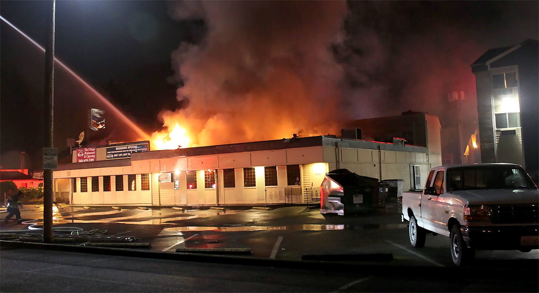 Water is poured on the early morning fire that did extensive damage to the Village Restaurant in Marysville on Sunday. (Marysville Fire District)