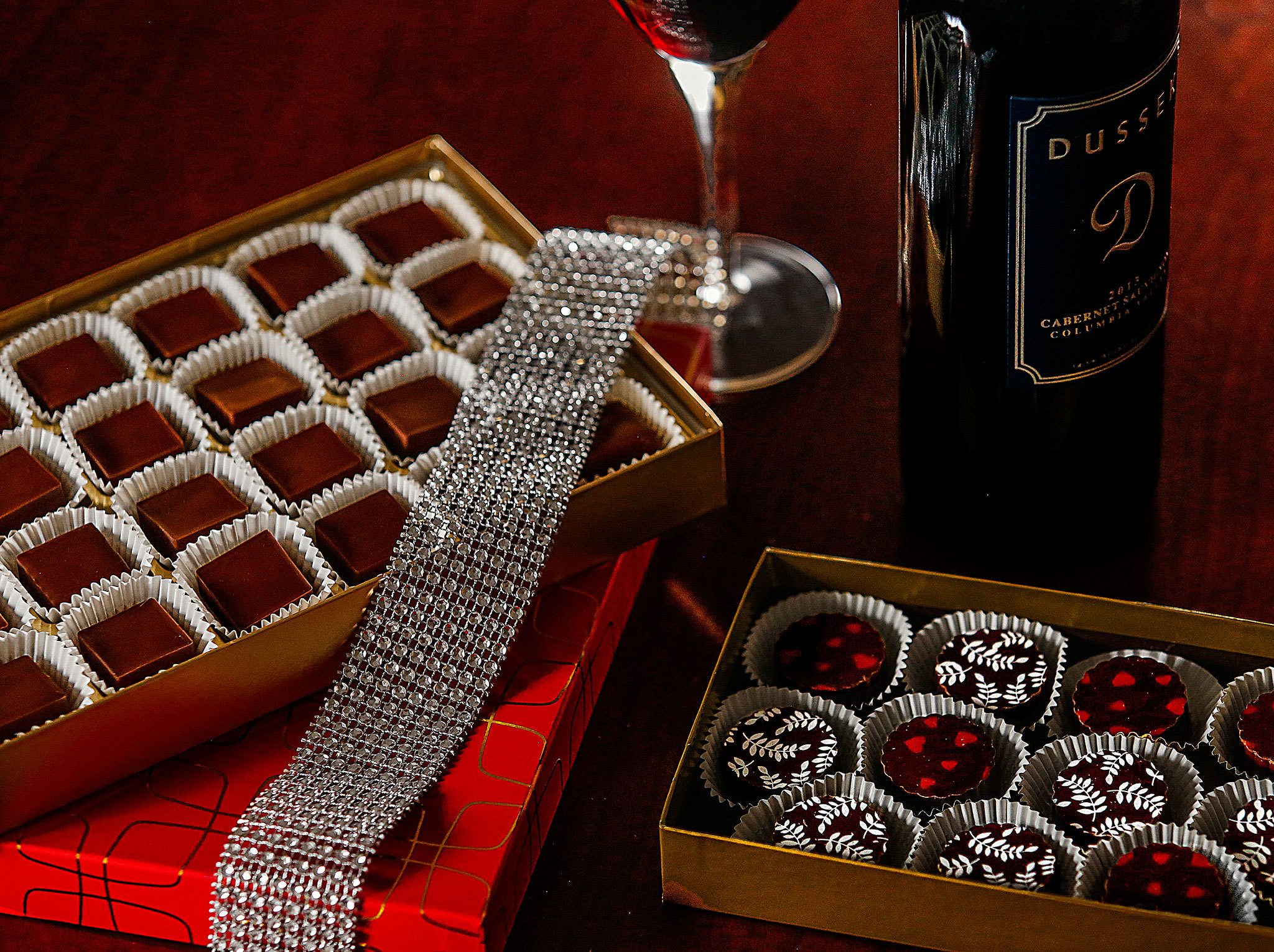 These chocolates were handmade by Windsor Vest for Domestic Violence Services of Snohomish County’s annual Chocolate Lovers Gala. At left are dark chocolate meltaways made with coconut oil. Vest likes to pair them with wine such as the Dussek cabernet sauvignon shown above. In the right foreground are Vest’s peanut clusters made with dark chocolate. The 25th annual gala is March 10 at the Tulalip Resort Casino. (Dan Bates / The Herald)