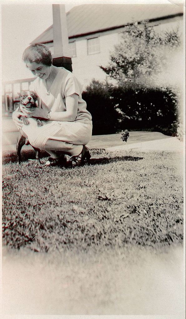 Longtime teacher and principal Frances Anderson in the 1930s, with her bobbed hair and smiling as she kneels to cuddle a dog, is part of a new photography exhibit, “Edmonds in Focus.” (Photo courtesy Edmonds Historical Museum)
