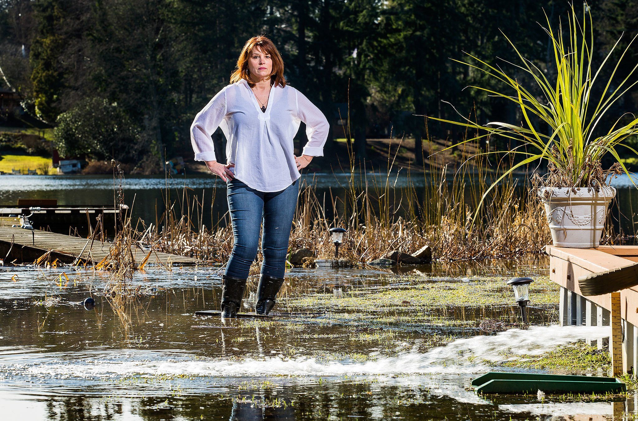 Lake Serene resident Debbie Bly-Olsen stands in her flooded yard on Feb. 1. (Andy Bronson / The Herald)