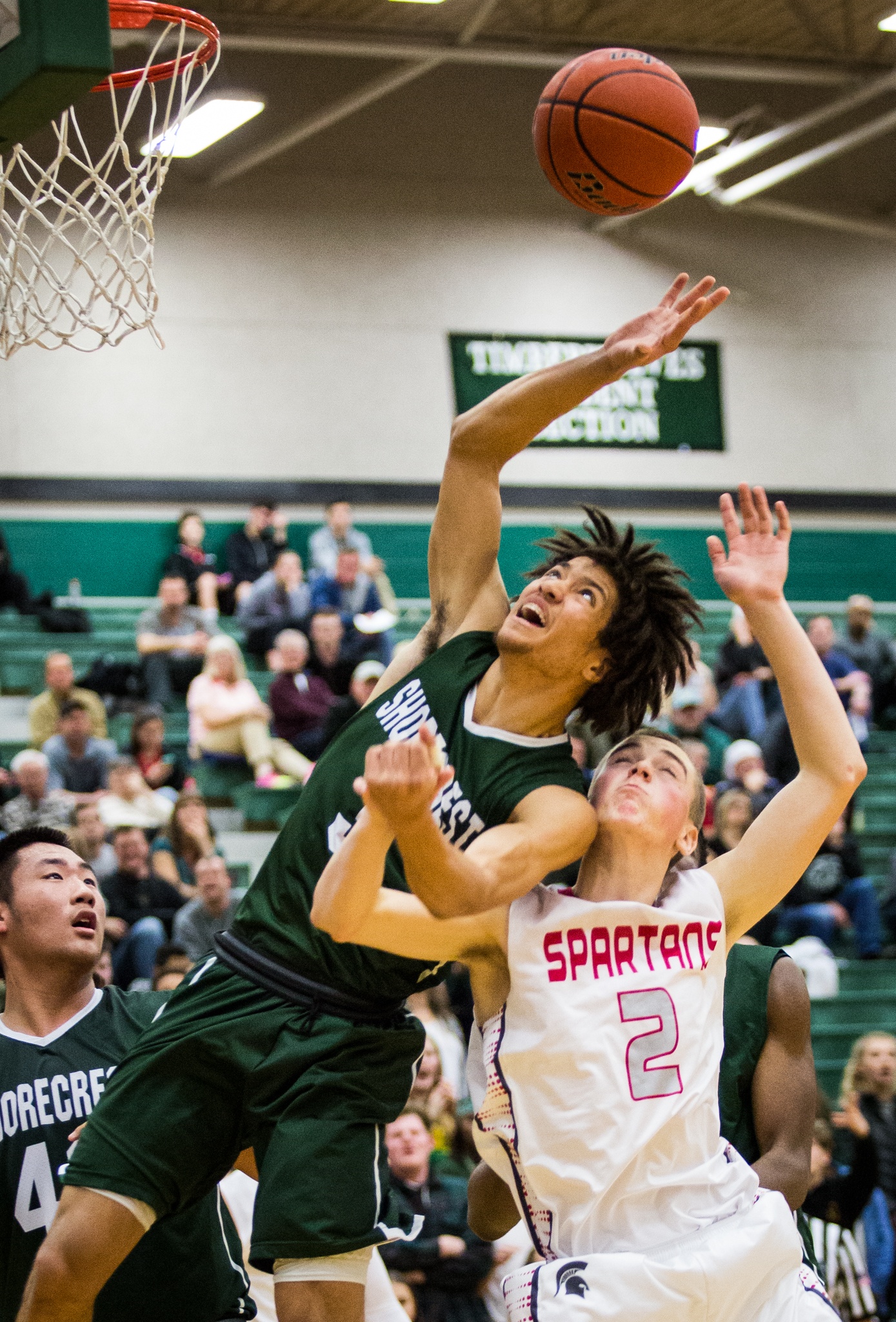 Shorecrest’s Malcolm Rosier-Butler (center) and Stanwood’s Bryson Kelley fight for the ball during the championship game of the 3A District 1 boys basketball tournament Feb. 17, 2017, at Jackson High School in Mill Creek. Shorecrest beat Stanwood 55-52. (Daniella Beccaria / The Herald)