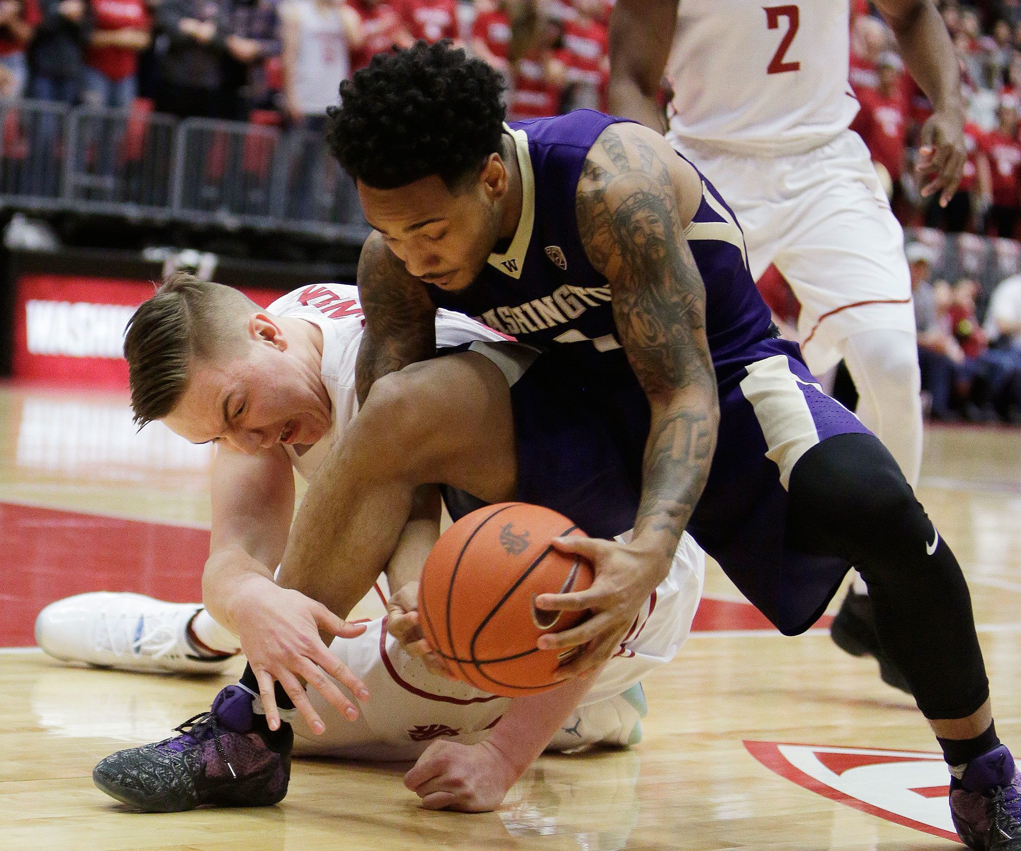 Young Kwak / Associated Press                                Washington State forward Josh Hawkinson (left) and Washington guard David Crisp battle for control of the the ball during the first half of their Pac-12 men’s basketball game Sunday in Pullman.