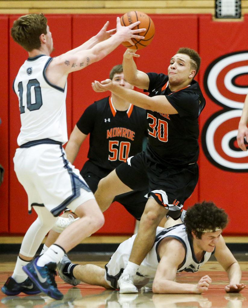 Monroe’s Isaiah Cole (30) battles for a loose ball with Glacier Peak’s Seiver Southard (10) and Bobby Martin (bottom) during the Class 4A District 1 boys basketball championship game at Everett Community College on Thursday, Feb. 16. (Ian Terry / The Herald)
