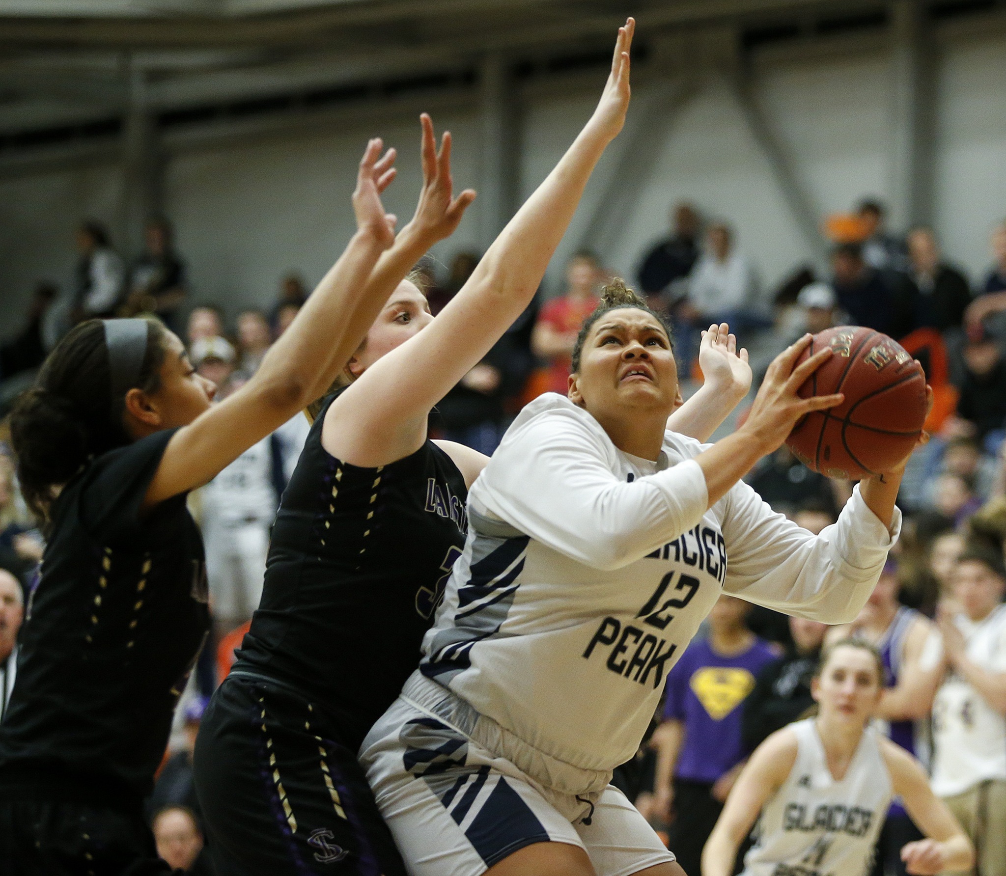 Glacier Peak’s Kayla Watkins (right) goes up for a shot during the Class 4A District 1 girls basketball championship game against Lake Stevens at Everett Community College on Thursday, Feb. 16. Glacier Peak went on to defeat Lake Stevens 60-41. (Ian Terry / The Herald)